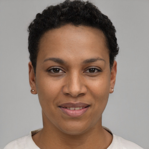 Joyful black young-adult female with short  black hair and brown eyes