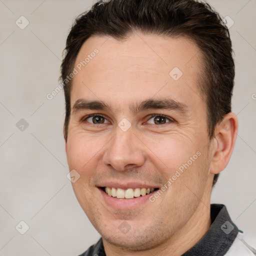 Joyful white adult male with short  brown hair and brown eyes