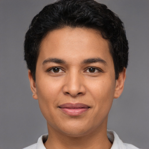 Joyful latino young-adult male with short  brown hair and brown eyes