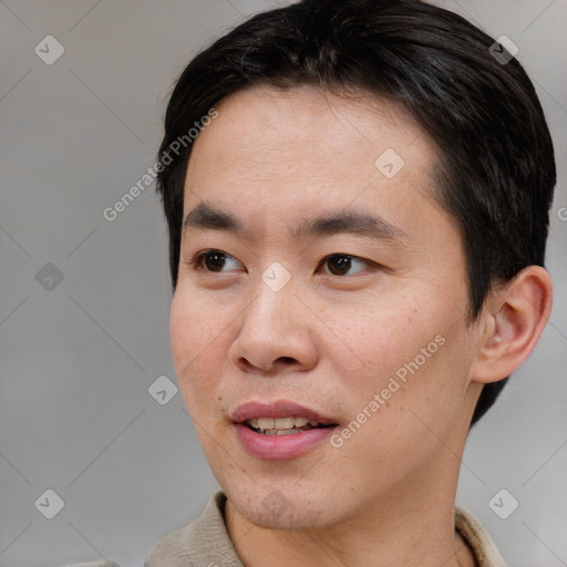 Joyful asian young-adult male with short  black hair and brown eyes