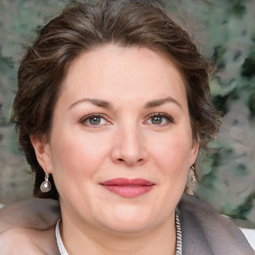 Joyful white adult female with medium  brown hair and grey eyes