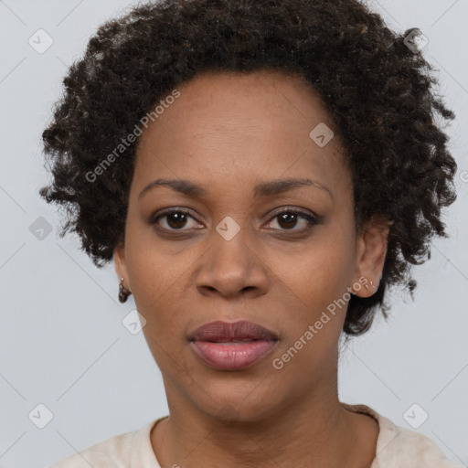 Joyful black adult female with short  brown hair and brown eyes