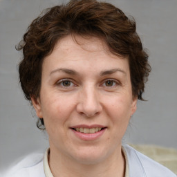 Joyful white adult female with short  brown hair and brown eyes