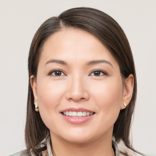 Joyful white young-adult female with medium  brown hair and brown eyes