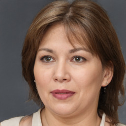 Joyful white adult female with medium  brown hair and brown eyes