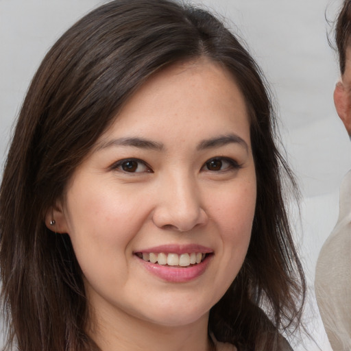 Joyful white young-adult female with medium  brown hair and brown eyes