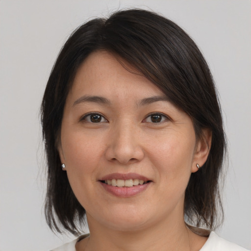 Joyful white young-adult female with medium  brown hair and brown eyes