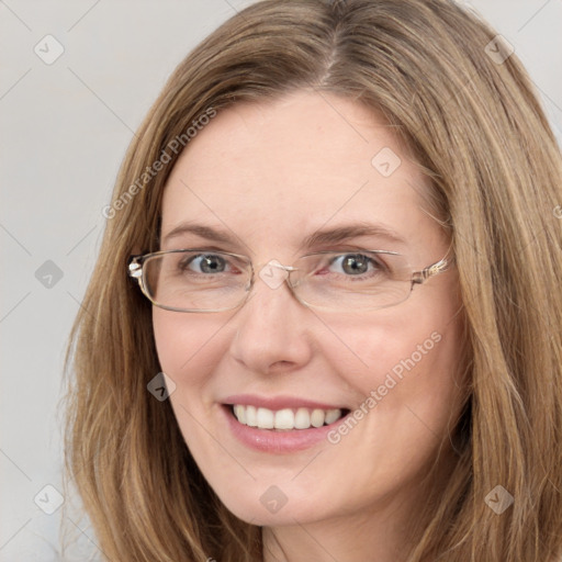 Joyful white young-adult female with long  brown hair and blue eyes