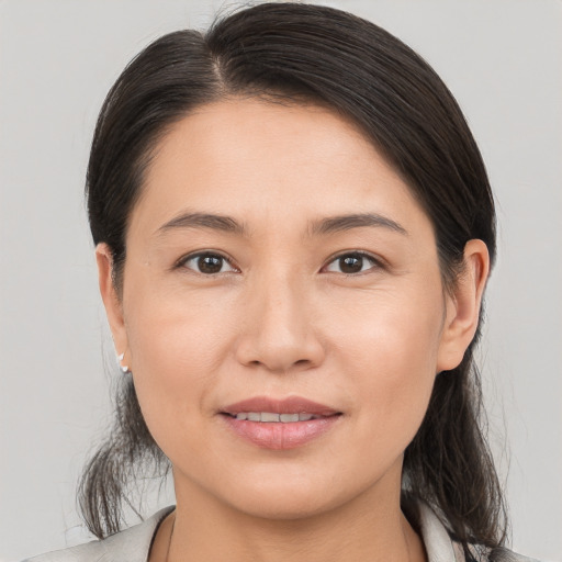 Joyful white young-adult female with medium  brown hair and brown eyes