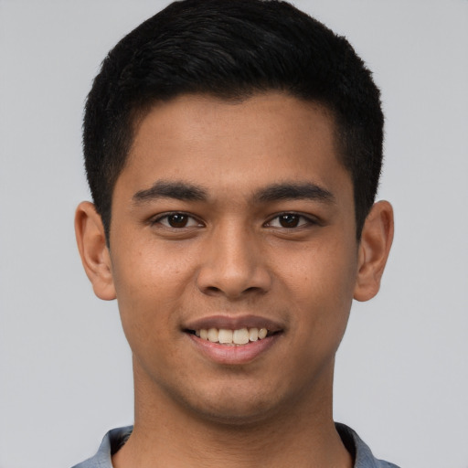 Joyful latino young-adult male with short  brown hair and brown eyes