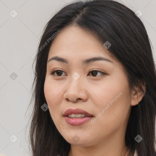 Joyful asian young-adult female with long  brown hair and brown eyes