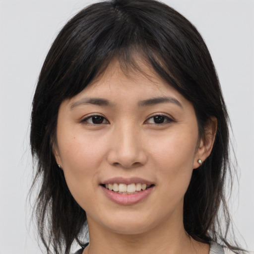Joyful asian young-adult female with medium  brown hair and brown eyes