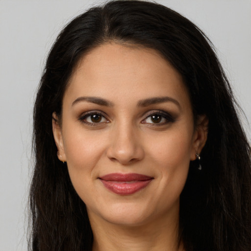 Joyful latino young-adult female with long  brown hair and brown eyes