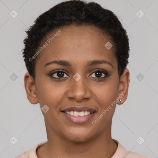 Joyful black young-adult female with short  brown hair and brown eyes