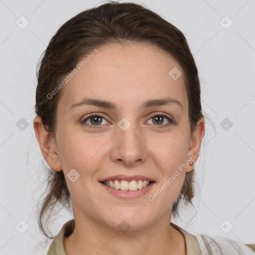 Joyful white young-adult female with medium  brown hair and grey eyes