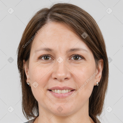 Joyful white adult female with medium  brown hair and brown eyes