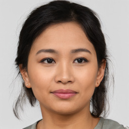 Joyful asian young-adult female with medium  brown hair and brown eyes