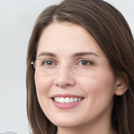 Joyful white young-adult female with long  brown hair and grey eyes