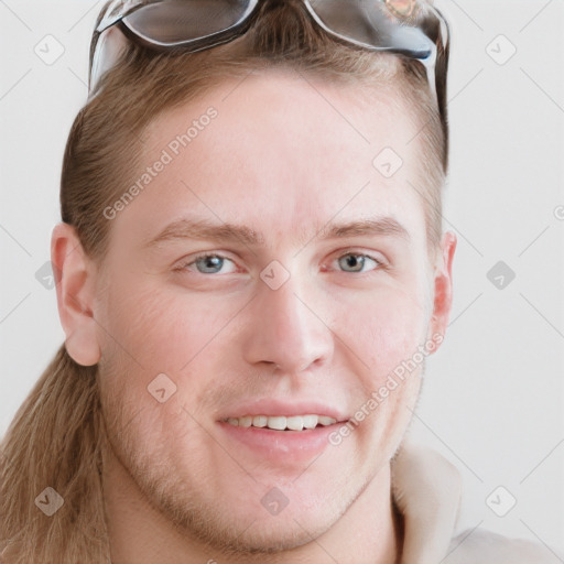 Joyful white young-adult male with short  brown hair and blue eyes