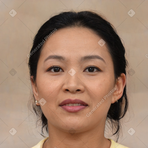 Joyful latino adult female with medium  brown hair and brown eyes