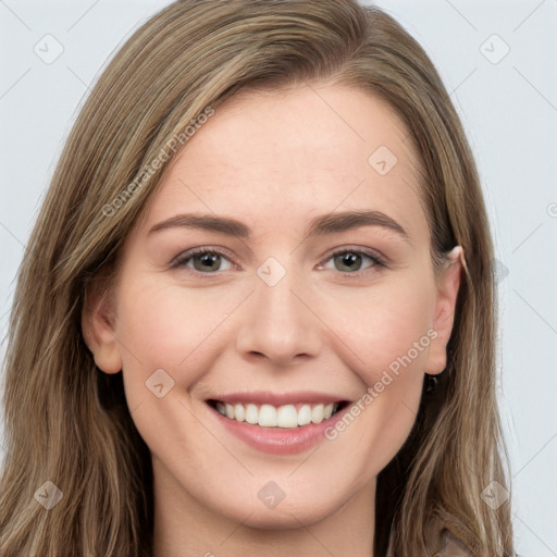 Joyful white young-adult female with long  brown hair and grey eyes