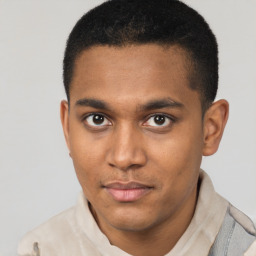 Joyful latino young-adult male with short  brown hair and brown eyes