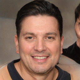 Joyful white adult male with short  brown hair and brown eyes