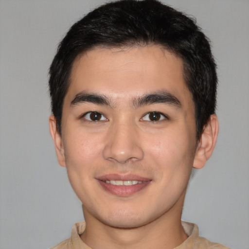 Joyful white young-adult male with short  black hair and brown eyes