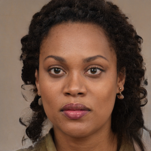 Neutral black young-adult female with long  brown hair and brown eyes