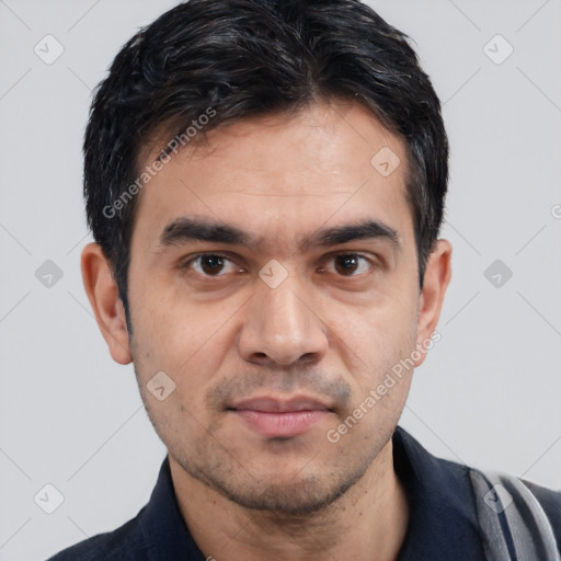 Joyful white young-adult male with short  black hair and brown eyes