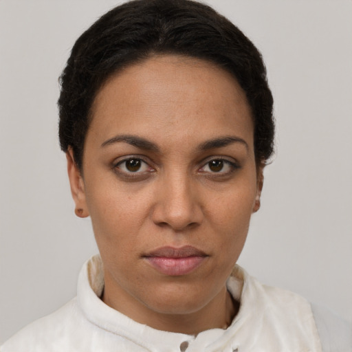 Joyful latino young-adult female with short  brown hair and brown eyes