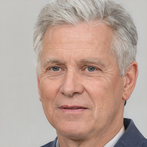 Joyful white middle-aged male with short  gray hair and brown eyes