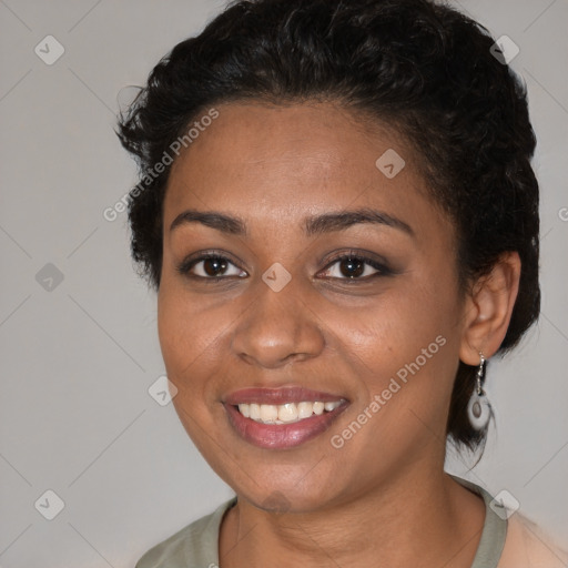 Joyful black young-adult female with short  brown hair and brown eyes