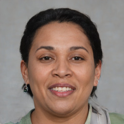 Joyful latino adult female with short  brown hair and brown eyes