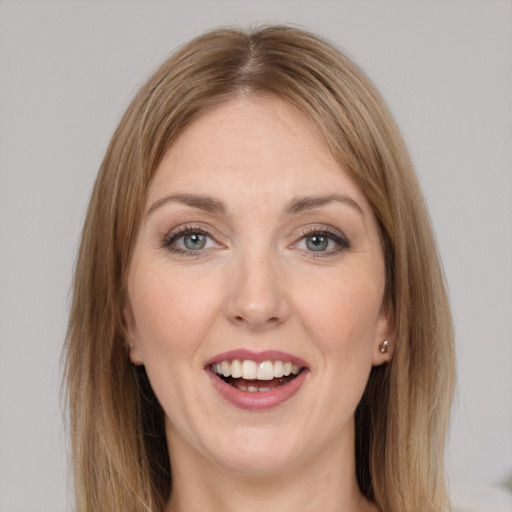 Joyful white young-adult female with long  brown hair and grey eyes