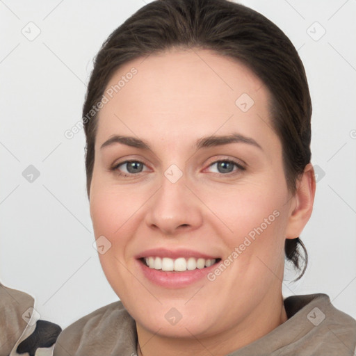 Joyful white young-adult female with short  brown hair and brown eyes