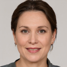 Joyful white adult female with medium  brown hair and grey eyes