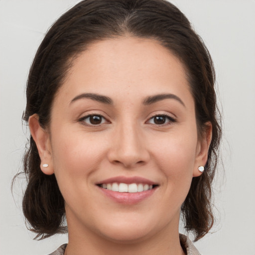 Joyful white young-adult female with medium  brown hair and brown eyes