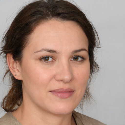 Joyful white adult female with medium  brown hair and brown eyes