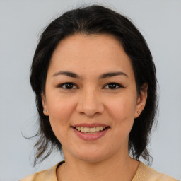 Joyful asian young-adult female with medium  brown hair and brown eyes