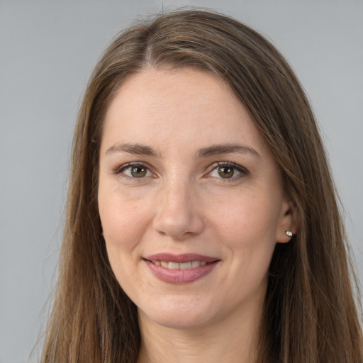 Joyful white adult female with long  brown hair and brown eyes