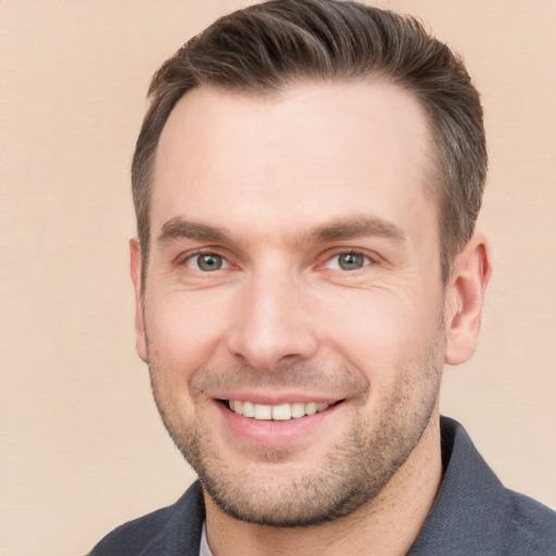 Joyful white young-adult male with short  brown hair and brown eyes