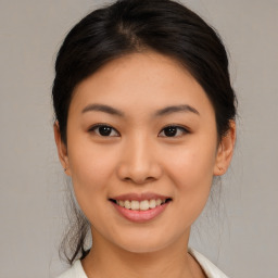 Joyful asian young-adult female with medium  brown hair and brown eyes