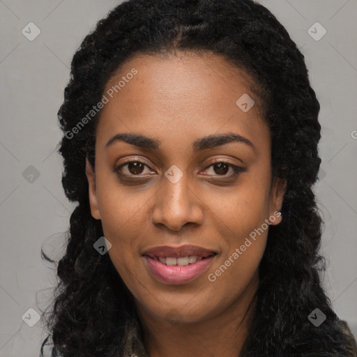 Joyful black young-adult female with long  black hair and brown eyes