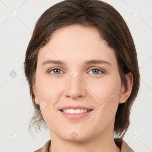 Joyful white young-adult female with medium  brown hair and grey eyes