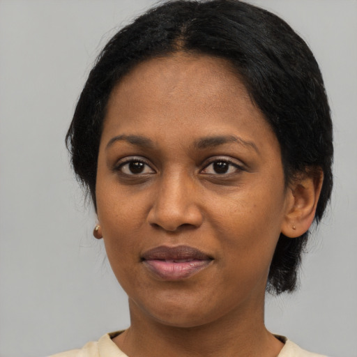 Joyful black young-adult female with medium  black hair and brown eyes
