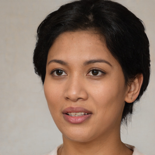 Joyful asian young-adult female with medium  brown hair and brown eyes