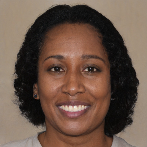 Joyful black adult female with medium  black hair and brown eyes