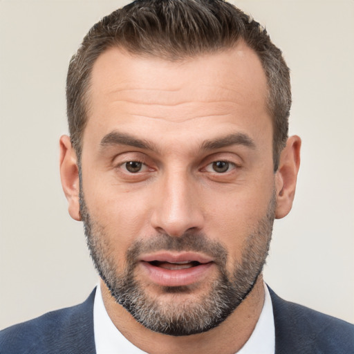 Joyful white adult male with short  brown hair and brown eyes