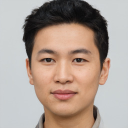 Joyful asian young-adult male with short  black hair and brown eyes